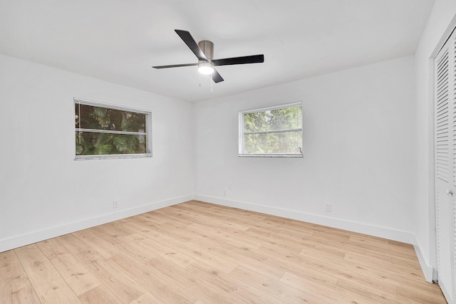 unfurnished bedroom featuring ceiling fan, a closet, and light wood-type flooring