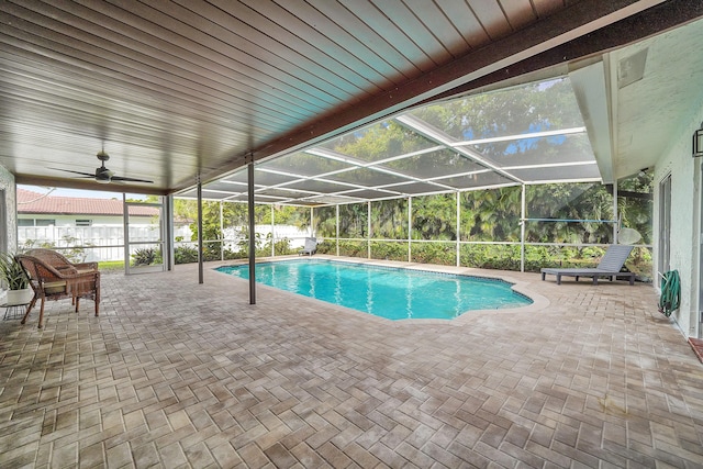 view of swimming pool with a lanai and a patio