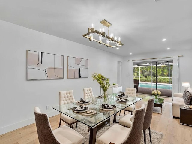 dining room with a chandelier and light hardwood / wood-style flooring