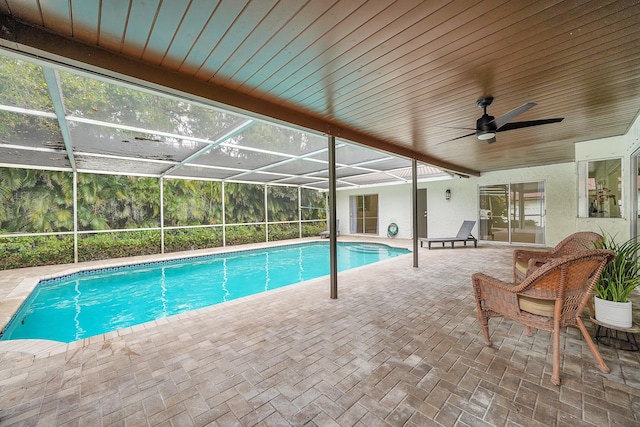 view of pool with a lanai, ceiling fan, and a patio