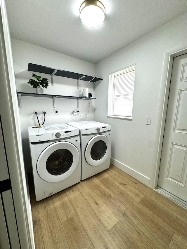 laundry area featuring light wood-type flooring and washing machine and clothes dryer