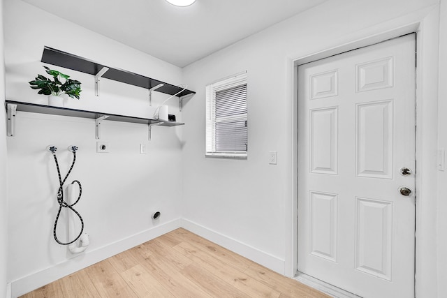 washroom featuring hardwood / wood-style flooring, hookup for a washing machine, and hookup for an electric dryer