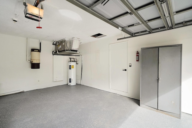 garage with water heater and a garage door opener