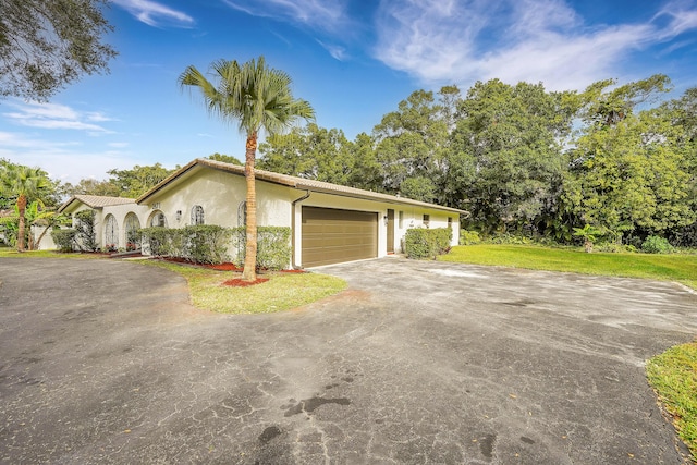 view of front of house with a garage and a front yard