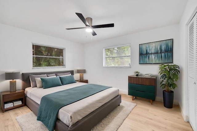 bedroom with ceiling fan, a closet, and light wood-type flooring