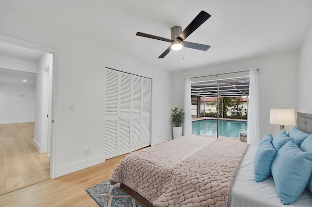 bedroom with ceiling fan, access to exterior, a closet, and hardwood / wood-style floors