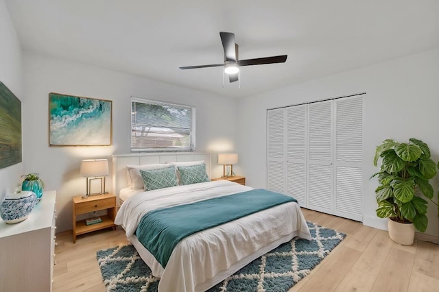 bedroom with ceiling fan, a closet, and light hardwood / wood-style floors