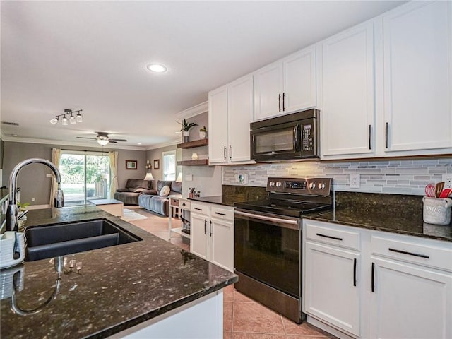 kitchen featuring sink, stainless steel electric stove, and white cabinetry