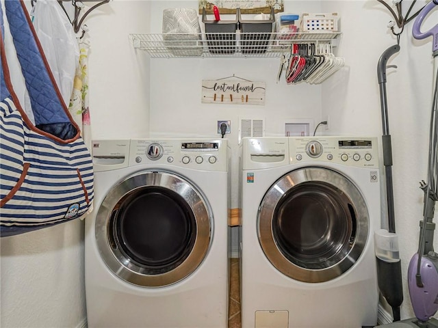 washroom with washing machine and clothes dryer