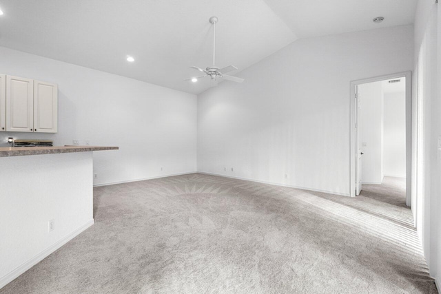 unfurnished living room featuring light carpet, ceiling fan, and lofted ceiling