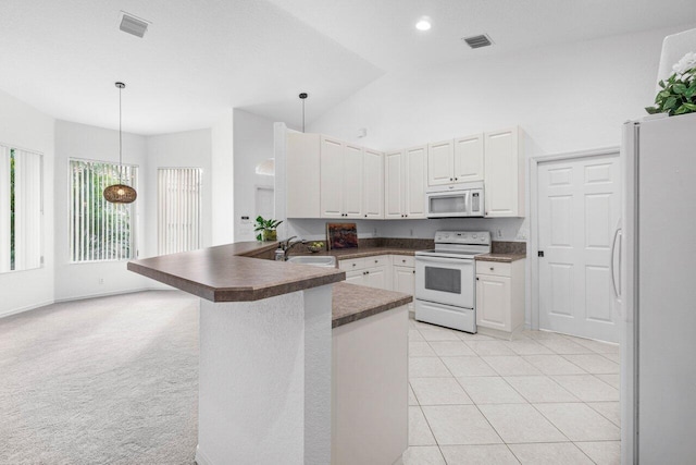 kitchen featuring white appliances, decorative light fixtures, white cabinetry, sink, and kitchen peninsula