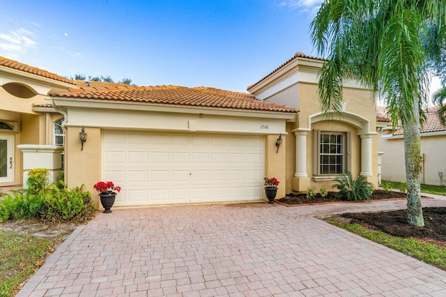 mediterranean / spanish house with a garage