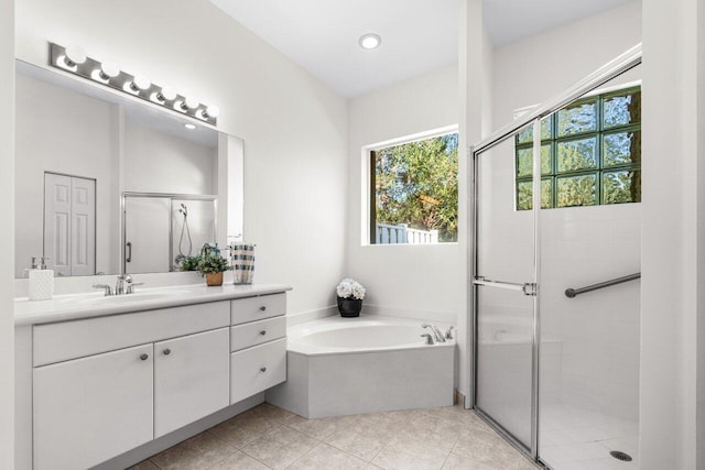 bathroom featuring tile patterned floors, vanity, and plus walk in shower