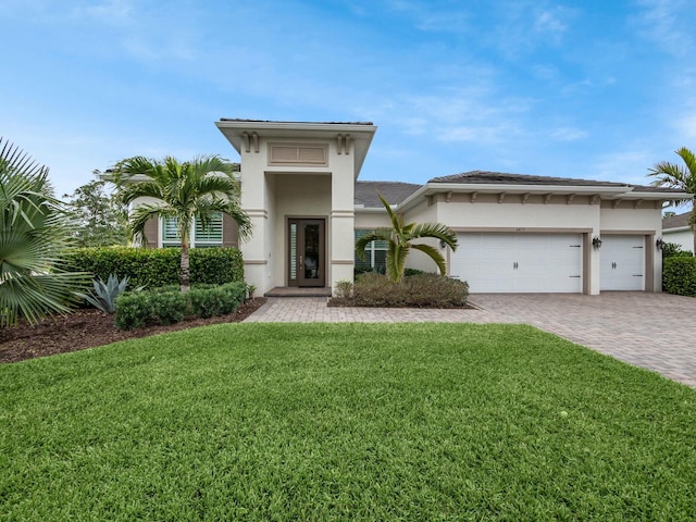 view of front of house with a garage and a front yard