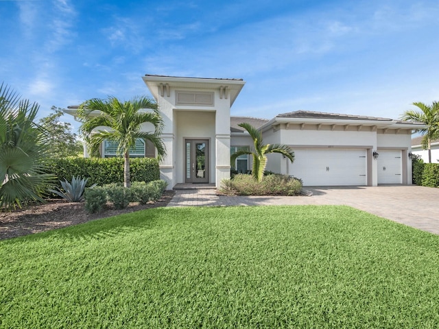 view of front of home with cooling unit, a garage, and a front lawn