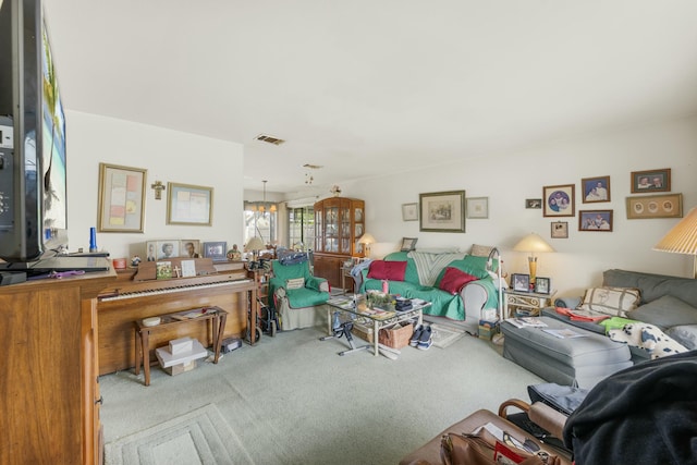 carpeted living room featuring a chandelier