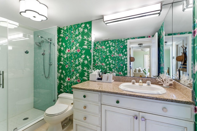 bathroom featuring toilet, walk in shower, and vanity