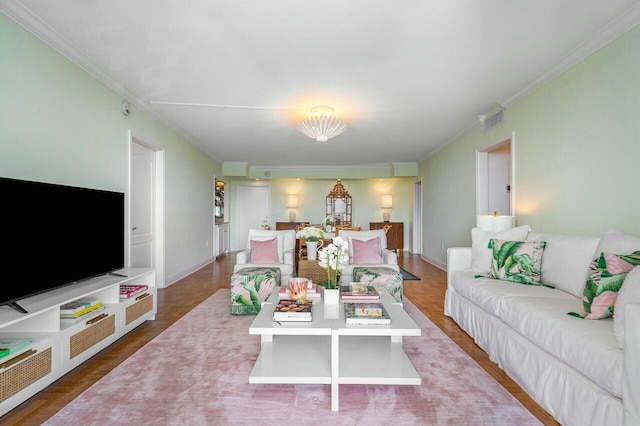 living room featuring hardwood / wood-style flooring and crown molding