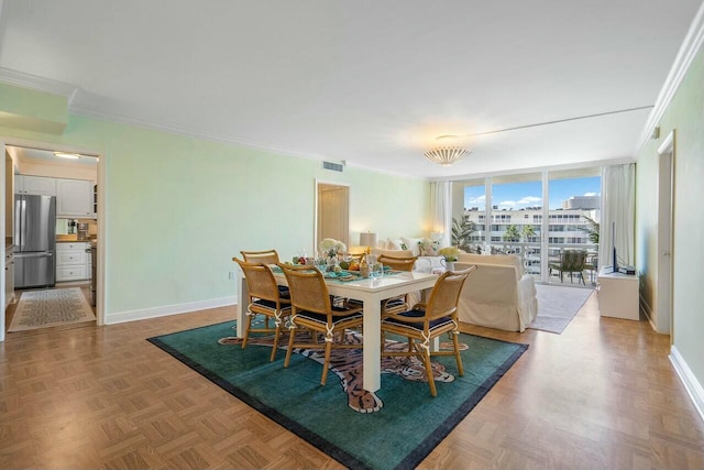 dining room with floor to ceiling windows, parquet flooring, and crown molding