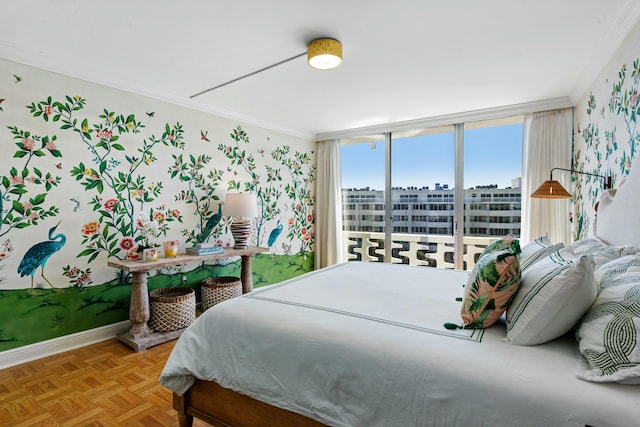 bedroom featuring ornamental molding, a wall of windows, and parquet flooring