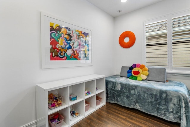 bedroom with dark hardwood / wood-style floors