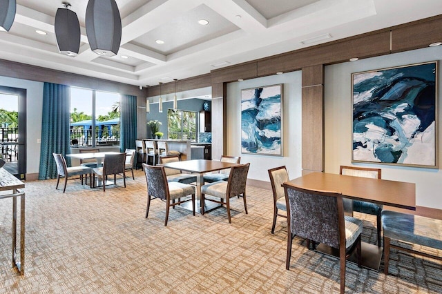 dining space featuring a towering ceiling, coffered ceiling, light colored carpet, and beam ceiling