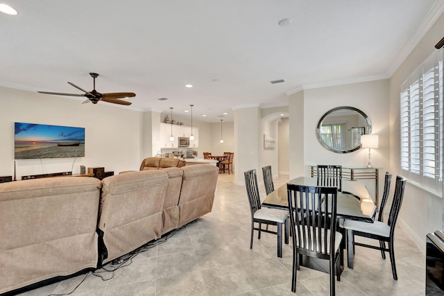 dining area featuring crown molding and ceiling fan