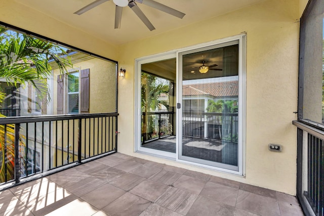 unfurnished sunroom featuring ceiling fan