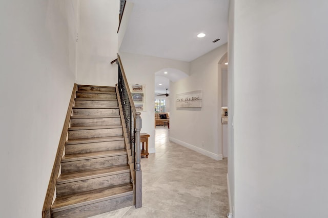 stairway with ceiling fan