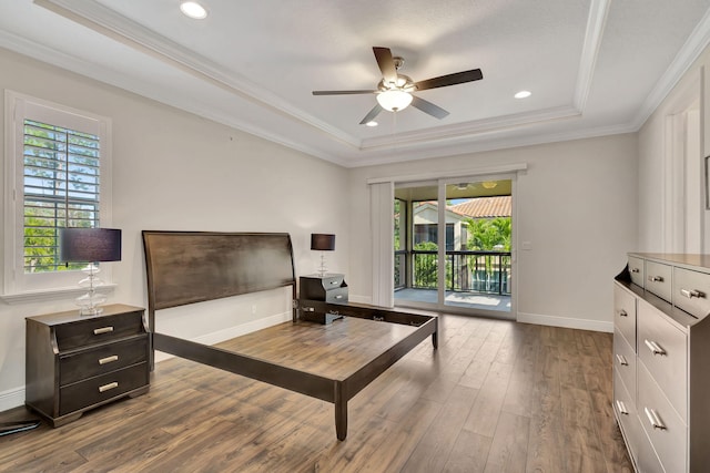 bedroom featuring crown molding, a tray ceiling, hardwood / wood-style flooring, ceiling fan, and access to exterior