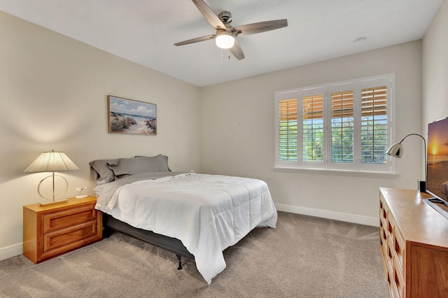 bedroom featuring ceiling fan and light carpet