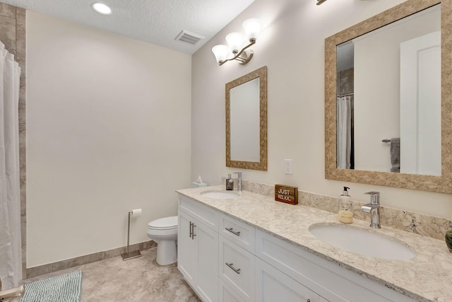 bathroom with a shower with shower curtain, vanity, a textured ceiling, tile patterned floors, and toilet