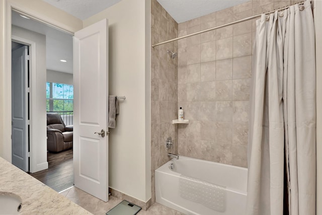 bathroom featuring shower / tub combo with curtain, vanity, and tile patterned floors