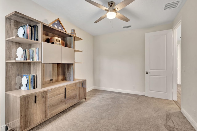 interior space with light carpet and ceiling fan