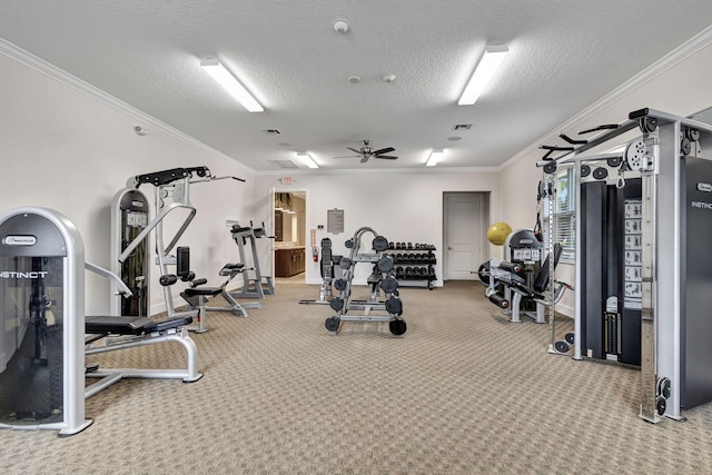 gym featuring ceiling fan, ornamental molding, a textured ceiling, and carpet