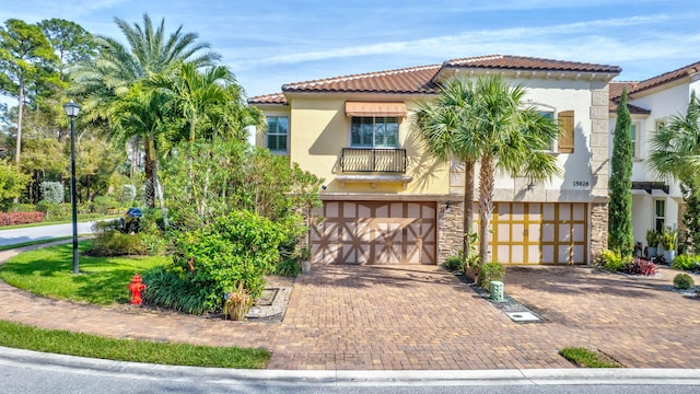 mediterranean / spanish-style house with a garage