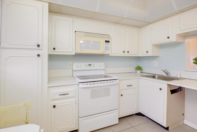 kitchen with light tile patterned flooring, sink, white cabinets, and white appliances