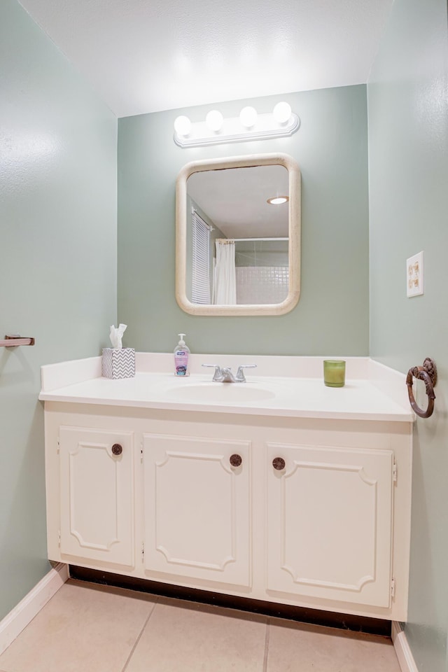 bathroom featuring tile patterned flooring and vanity