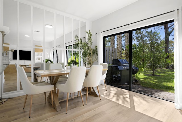 dining space with visible vents and wood finished floors