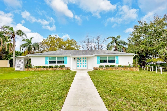 ranch-style house with a front yard and french doors