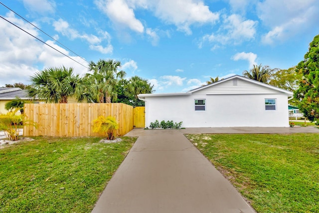 view of side of home featuring a lawn