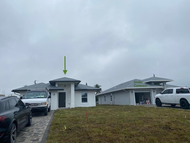 view of front of house with a front yard and a garage