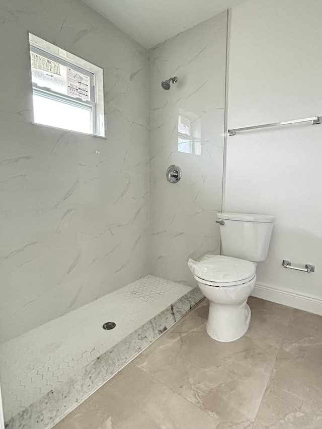 bathroom with toilet and tiled shower