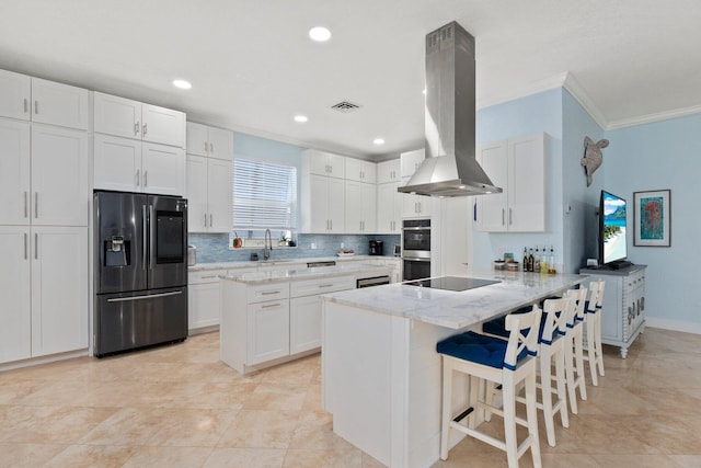 kitchen featuring white cabinets, island exhaust hood, stainless steel appliances, kitchen peninsula, and light stone counters