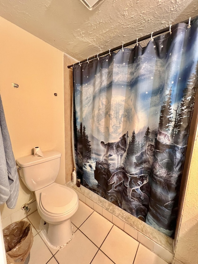 bathroom featuring toilet and tile patterned flooring