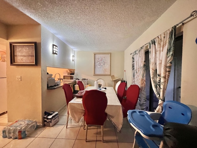 dining room with light tile patterned floors and a textured ceiling