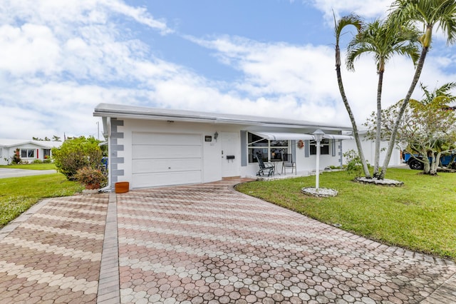 ranch-style home featuring a garage and a front yard