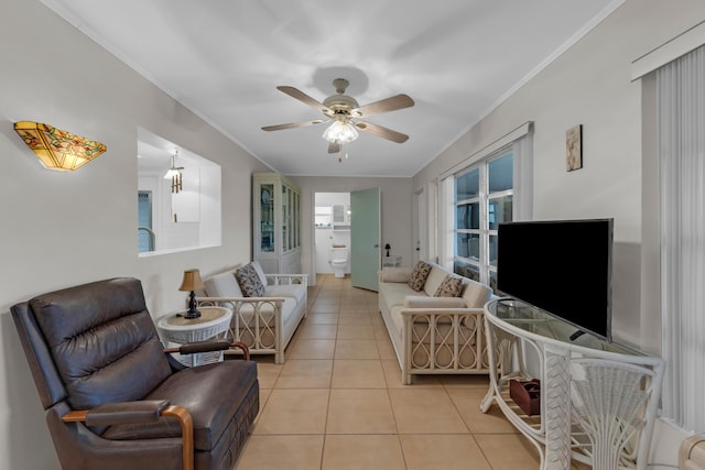 living room with crown molding, ceiling fan, and light tile patterned flooring