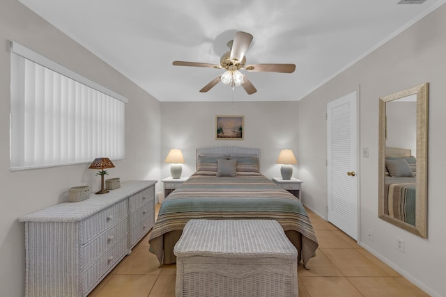 bedroom featuring light tile patterned floors and ceiling fan