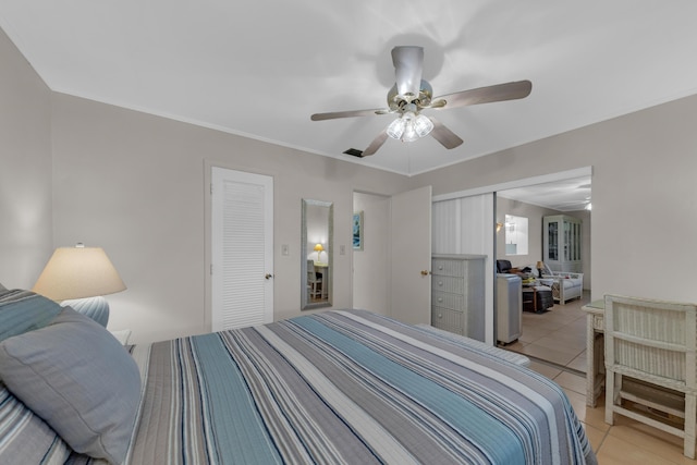 bedroom featuring light tile patterned flooring and ceiling fan